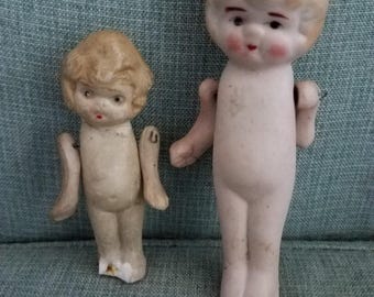 Antique all bisque little frozen Charlotte penny dolls with articulated arms. Made in Japan