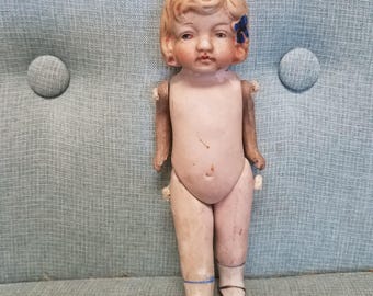 Antique 20s bisque articulated little blonde doll / frozen Charlotte with blue ribbon in hair, made in Japan 5 1/2 inches tall.