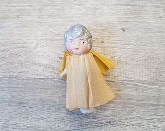 1900s silver haired bisque frozen Charlotte / penny doll with moving arms, crepe paper dress and cape