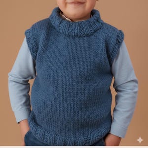 May include: A blue knitted vest with a turtleneck collar. The sleeveless garment is made of a chunky knit and is worn over a light blue long-sleeved shirt. The vest has a ribbed hem and a slightly ruffled edge at the shoulders.