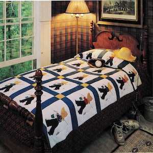 May include: A quilt with a repeating pattern of figures carrying fishing gear. The quilt features a white background with blue and yellow accents. A baseball, a yellow hat, and a pair of sneakers are on the bed.