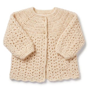 May include: A cream-coloured, crocheted cardigan with three-quarter sleeves and a scalloped hem. The button-down sweater is made of a textured yarn and features three round buttons. A handmade, cosy garment.