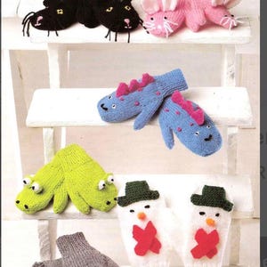 May include: A collection of knitted mittens in various animal designs. Includes black cat, pink bunny, blue dinosaur, green frog, snowman, and gray mouse mittens. Each pair features detailed facial features and unique designs.
