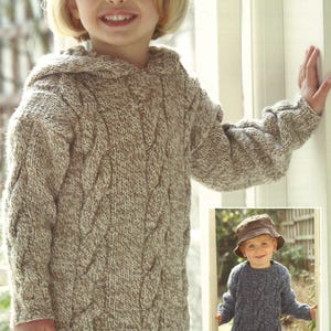 May include: A cable-knit hooded sweater in shades of brown and cream. The sweater features a textured design and is worn by a child. A smaller image shows a child wearing a similar blue sweater and a hat.