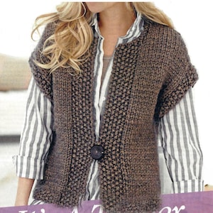 May include: A brown, sleeveless knitted vest with a large, dark button closure. The vest has a textured stitch pattern and is worn over a striped shirt. The overall style is casual and comfortable.