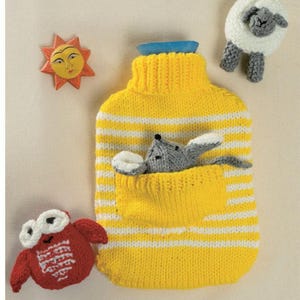 May include: A yellow knitted hot water bottle cover with white stripes, featuring a pocket with a gray mouse. Includes a red owl, a sun, and a sheep, all knitted. The cover has a blue stopper.