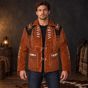 May include: A brown suede jacket featuring long fringe detailing, white bone-like accents, and black shoulder panels with colorful embroidered patterns. The jacket includes two front tie closures and is worn over a plain black shirt and blue jeans.