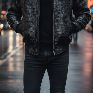 May include: A black leather bomber jacket with a crocodile skin texture, paired with a black crew neck shirt and dark wash jeans. The jacket has a zipper closure and ribbed cuffs. The person is standing on a wet street.