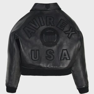 May include: Black leather jacket featuring the word "AVIREX" arched across the back, above "USA". The jacket has a ribbed hem and cuffs. A circular emblem is centered between the brand name and the country.