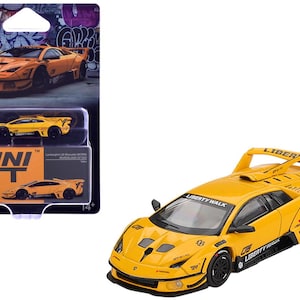 May include: A yellow Lamborghini diecast model car with black accents and a rear spoiler. The car is labeled "Liberty Walk" and "05". The packaging shows the car and the "MINI GT" logo. The model is for ages 14+.