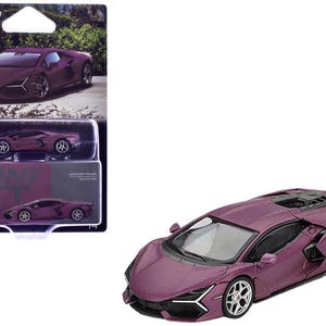 May include: A plum-colored diecast Lamborghini model car with silver wheels. The car is displayed outside of its packaging, and the packaging is also visible. The packaging has the words "MINI GT" printed on it.