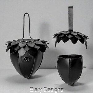 May include: Black leather handbag with a unique acorn design. The bag features a petal-like top, a handle, and a small clasp. The design includes a separate top and a detached base, showcasing the bag's components.