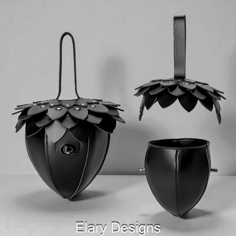 May include: Black leather handbag with a unique acorn design. The bag features a petal-like top, a handle, and a small clasp. The design includes a separate top and a detached base, showcasing the bag's components.
