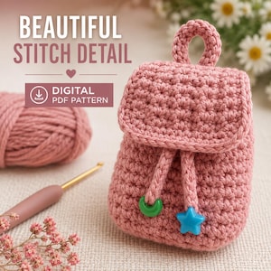 May include: A dusty rose crochet backpack with a top handle, a flap closure, and two drawstring cords ending in a green crescent moon bead and a blue star bead. Text reads BEAUTIFUL STITCH DETAIL and DIGITAL PDF PATTERN with a download icon.