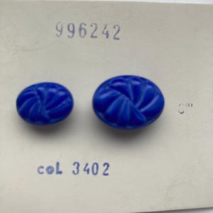 May include: Two oval cobalt blue buttons with a spiral design, displayed on a white card. The card has the stamped text "996242" and "col 3402".