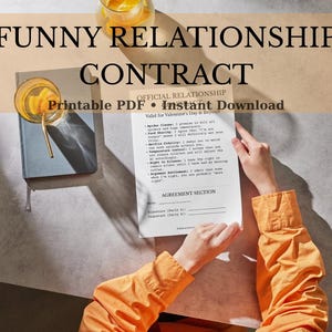 May include: A humorous relationship contract with the text "FUNNY RELATIONSHIP CONTRACT" and "OFFICIAL RELATIONSHIP" at the top. The document is held by a person wearing an orange shirt. A drink and a book are also visible.
