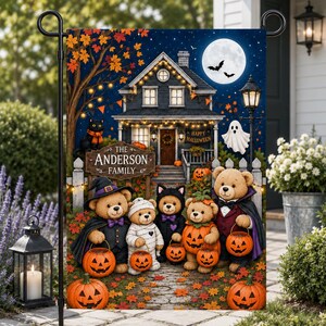 May include: A rectangular garden flag featuring a Halloween scene with a house, a full moon, and five teddy bears in costumes. The sign reads The Anderson Family and Happy Halloween. The bears hold jack-o'-lantern buckets amidst autumn leaves.