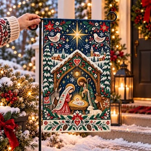 May include: A rectangular garden flag featuring a colorful nativity scene with a central manger, figures of Mary and Joseph, a donkey, a cow, and a lamb. The design includes a bright star, snowy pine trees, poinsettias, and hearts on a dark blue background.