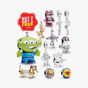 May include: A collection of silver and enamel charms featuring Toy Story characters including a green alien, Lotso bear, Woody, Buzz Lightyear, Slinky Dog, and a Toy Story logo bead, alongside a gold cowboy boot charm and a red, yellow, and blue ball charm.