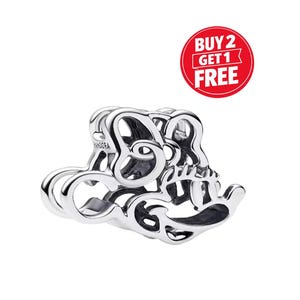 May include: A silver charm with the word "Pandora" engraved on the side. The charm is in the shape of the word "Love" in a cursive font. A red circle with the text "BUY 2 GET 1 FREE" is in the upper right corner.