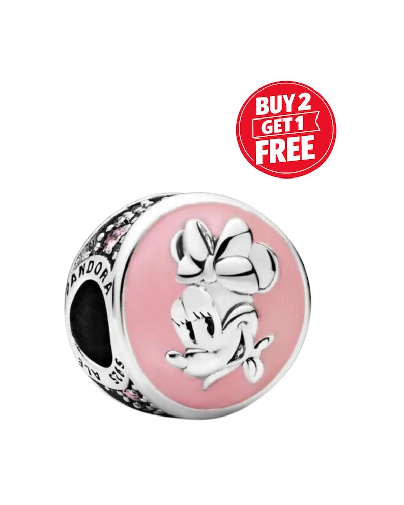 May include: A silver charm with a pink enamel Minnie Mouse design. The charm has the word "Pandora" engraved on the side and the text "Buy 2 Get 1 Free" in a red circle.