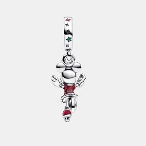 May include: A silver charm featuring a character with round ears, wearing a red glittery dress and red skates. The bail is decorated with small, colorful star-shaped accents in red, black, and green, adding a subtle touch of color to the metallic finish.