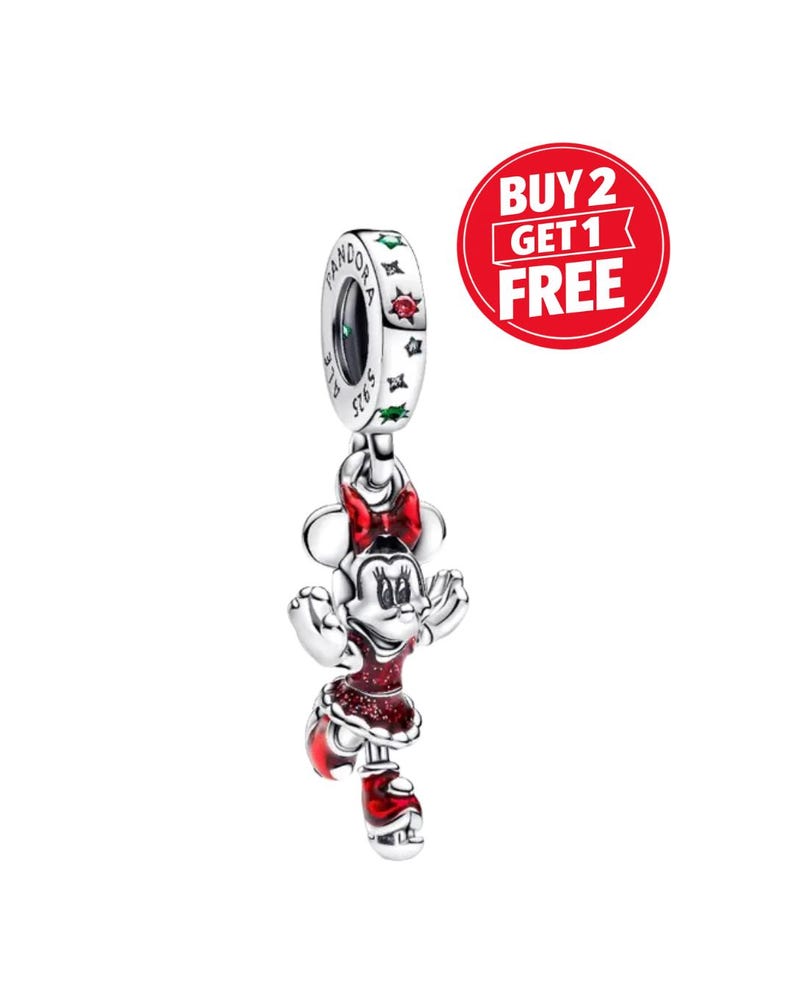 May include: A silver charm featuring a character with a red bow, red dress, and red shoes with glitter accents. The charm hangs from a silver ring engraved with the word PANDORA and S925, decorated with small red and green star-shaped stones.