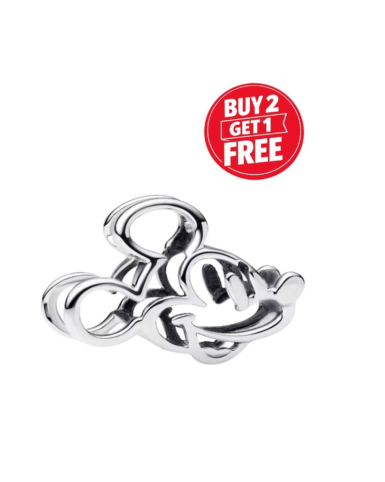 May include: A silver ring in the shape of Mickey Mouse's head. The ring is made of a shiny metal and has a smooth, polished finish. A red circle with the text "BUY 2 GET 1 FREE" is in the background.
