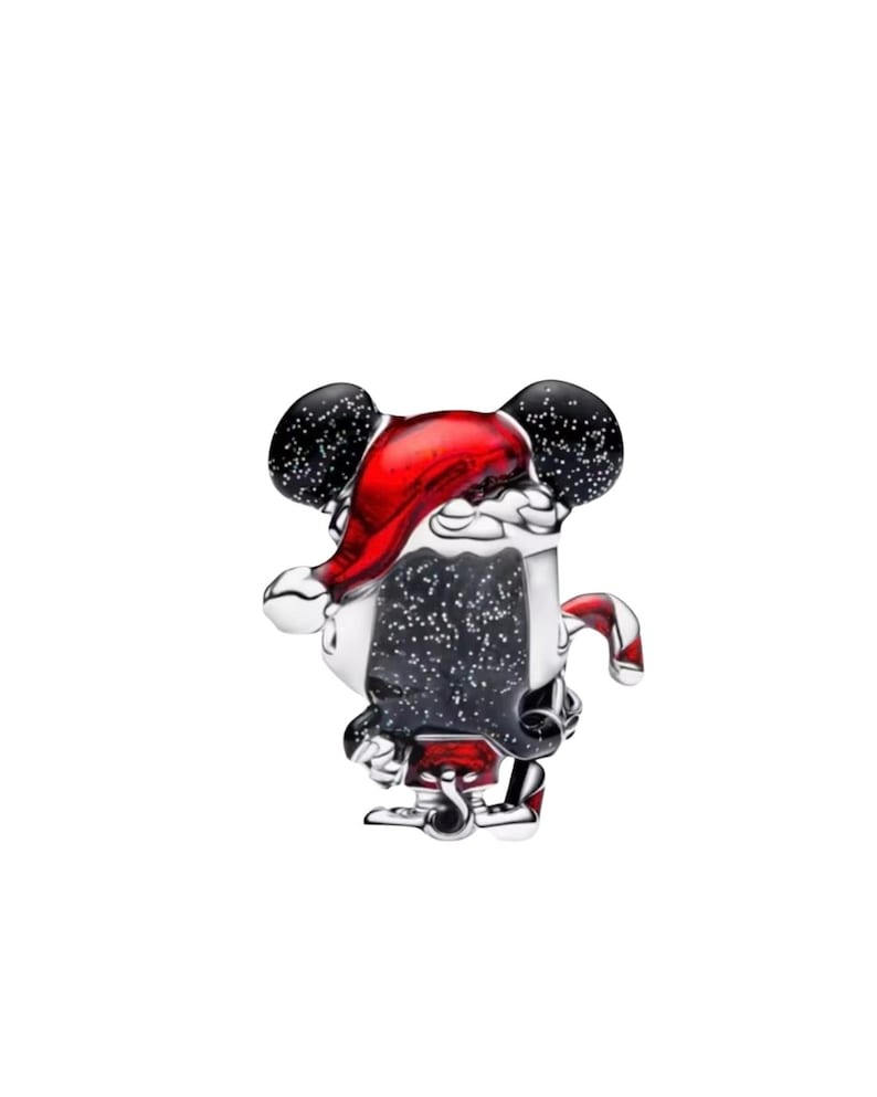May include: A silver charm with a festive design. The charm depicts a character wearing a Santa hat and suit. The character's ears are black with white speckles. The hat is red, and the suit is white and black.