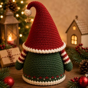 May include: A crochet gnome figurine featuring a tall red pointed hat with a white pom-pom and a gold star charm. The body is dark green with red and white striped sleeves and a white hem featuring a small red pattern at the base of the figure.