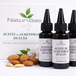 May include: Three black bottles of Natur Sais sweet almond oil, each containing 35 ml, with a white label and a green leaf logo. The bottles are next to almonds, almond shells, and a white box with the Natur Sais logo.