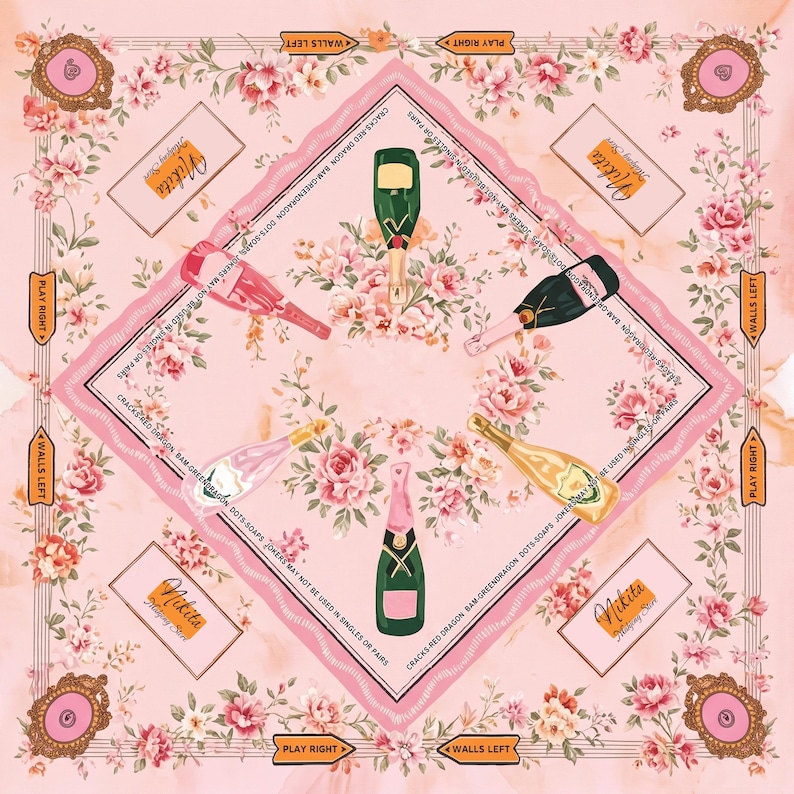 May include: A square scarf with a light pink background featuring a floral pattern of pink roses. The design includes five champagne bottles in various colors, the text "Nikita Mahjong Set", and border text reading "CRACKS-RED DRAGON BAM-GREEN DRAGON DOTS-SOAPS JOKERS MAY NOT BE USED IN SINGLES OR PAIRS".