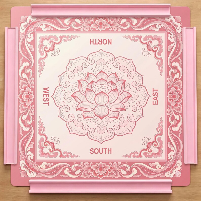 May include: A square pink game board featuring a central lotus flower illustration surrounded by intricate floral and cloud patterns. The board includes four raised pink side rails and the directional labels North, South, East, and West printed in pink.