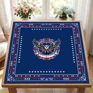 May include: A square, navy blue table cover with a patriotic design. The center features a detailed eagle emblem with the letters "BWH". The border is decorated with red, white, and blue stars and arrows.