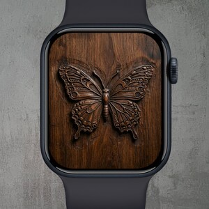 May include: A dark navy smartwatch with a wooden face featuring a detailed, carved butterfly design. The butterfly is a rich brown color, set against the wood grain. The watch has a dark navy band and a digital display.