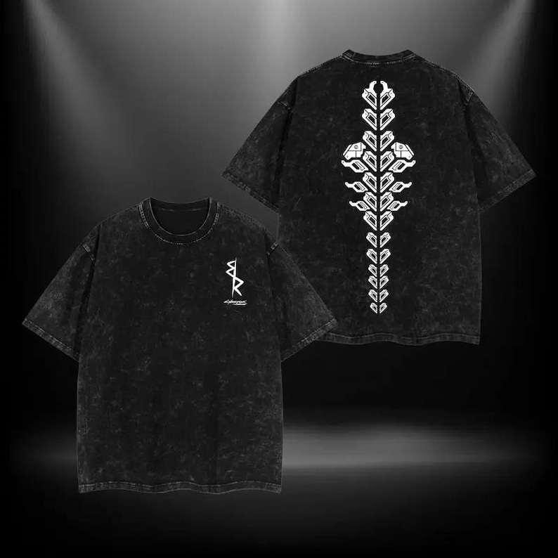 May include: Two black t-shirts with a white graphic design. One shirt has a small design on the front, and the other has a larger, vertical design on the back. The shirts have a faded, textured appearance.