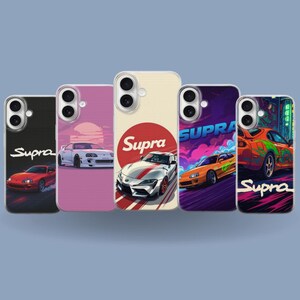 May include: A collection of five phone cases featuring car designs. Each case showcases a different car illustration, with the word "Supra" prominently displayed. The cases vary in color, including black, pink, cream, purple, and green, with the car graphics in vibrant hues.