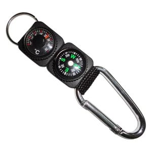 May include: A black keychain featuring a compass and a thermometer. The compass has a white dial with green and black markings. The thermometer displays Celsius. A silver carabiner clip is attached.