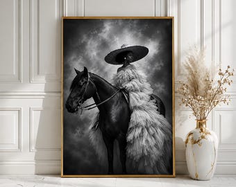 May include: A black and white framed wall art print depicting a person wearing a wide-brimmed hat and a voluminous, layered tulle gown while mounted on a dark horse. The scene is set against a dramatic, cloudy sky, captured in a vertical orientation.