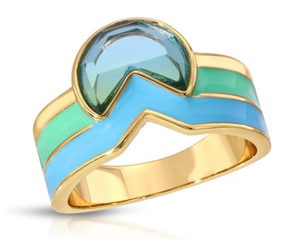 May include: Gold ring with a blue and green enamel design and a large, faceted, light blue gemstone.