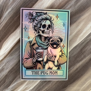 May include: A white ceramic mug with a black handle and the text "But First, Coffee" in a handwritten style. The mug is on a white surface. The mug is approximately 4 inches tall.