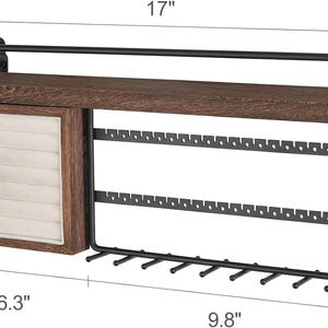 May include: A wooden and metal jewelry organizer. The organizer has a dark brown wooden shelf, a drawer with a cream-colored interior, and a black metal earring and necklace display. The shelf is 17 inches long.