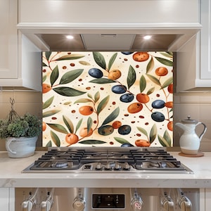 May include: A decorative kitchen backsplash featuring a watercolor design of olives and olive branches. The design includes green leaves, blue and orange olives, and small brown coffee bean accents on a cream background.
