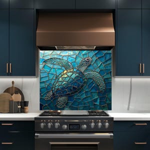 May include: A mosaic tile kitchen backsplash with a sea turtle design in shades of blue and turquoise. The backsplash is above a black stove, with dark blue cabinets and a copper range hood in the background.