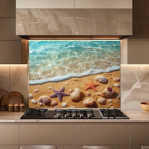 May include: A rectangular kitchen splashback panel featuring a high-resolution print of a sandy beach shoreline. The image displays turquoise ocean waves with white foam, a purple starfish, an orange starfish, and various seashells.