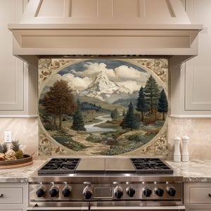 Peut inclure: Une crédence de cuisine avec une peinture de paysage d'une chaîne de montagnes, d'une rivière et d'arbres. L'œuvre d'art est encadrée dans un design circulaire avec une bordure décorative. La scène est située devant une cuisinière en acier inoxydable et des armoires de couleur claire.