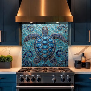 May include: A square kitchen backsplash panel featuring a mosaic design of a sea turtle in shades of deep blue and turquoise. The turtle is centered with intricate tile patterns surrounding it, set against a dark blue kitchen cabinet backdrop.