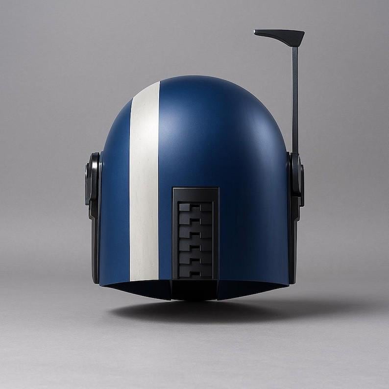 May include: A blue and white helmet with a vertical white stripe down the center. The helmet has black accents, including side details and a top antenna. The design is sleek and futuristic, suggesting a sci-fi or cosplay theme.