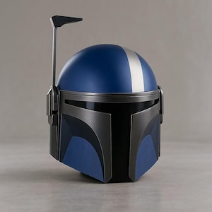 May include: A blue and silver helmet with a distinctive design. The helmet features a blue dome with a silver stripe down the center and a black visor. A vertical antenna extends from the top. The helmet is likely a costume or collectible item.