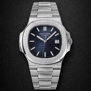 May include: A stainless steel wristwatch with a blue dial. The watch features a date display at the 3 o'clock position and the text "SPECHT & SÖHNE AUTOMATIC". The watch has a brushed metal finish and a link bracelet.